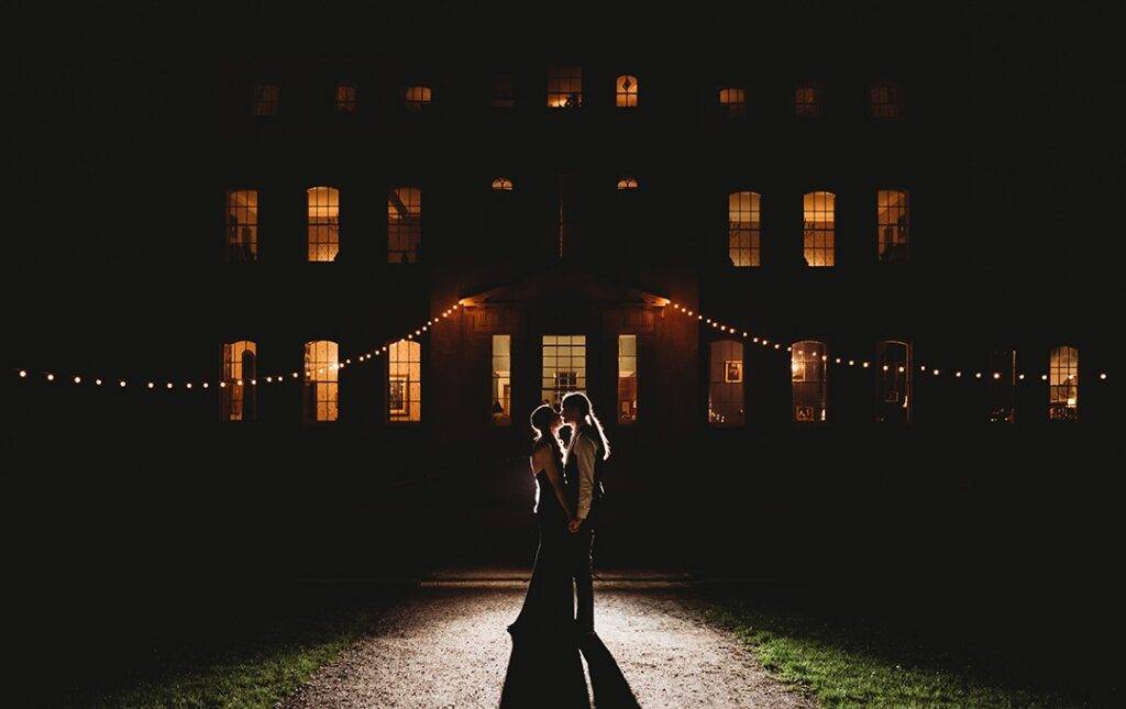 Kingsweston House lit up at night with couple in front of it