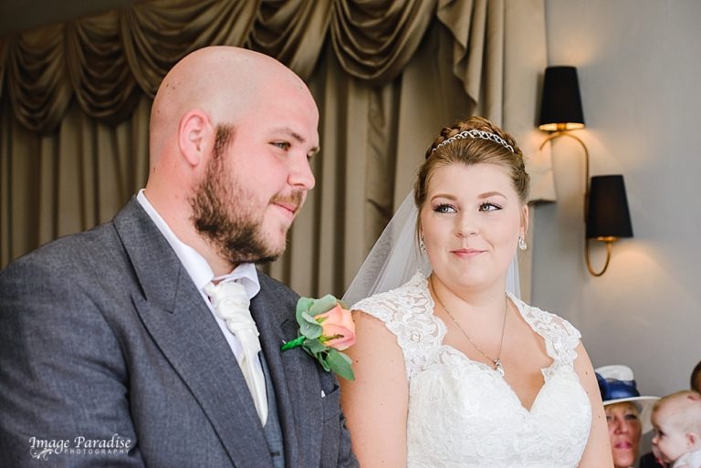 Bride smiles at her groom at the Mercure Bristol North