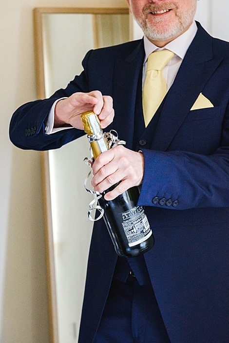 Bristol zoo wedding 5 man opening champagne in celebration of Bristol zoo wedding