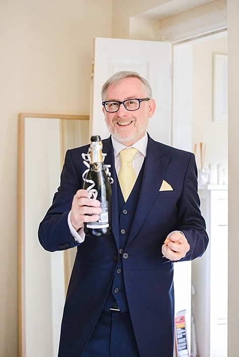 Bristol zoo wedding 6 Father of the bride opening champagne for daughters Bristol zoo wedding