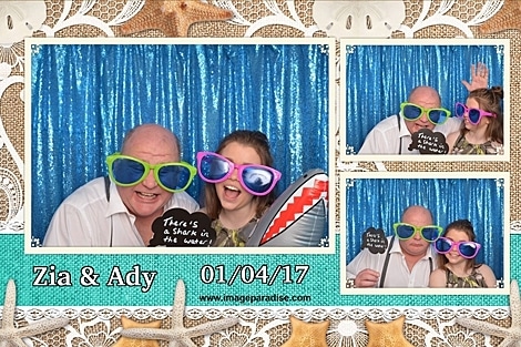 inflatable shark, silly sun glasses are worn in this beach themed wedding photo booth