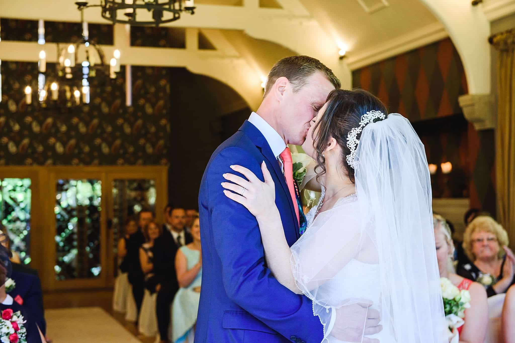 Bride and groom kiss after their wedding ceremony at the Hare and hounds