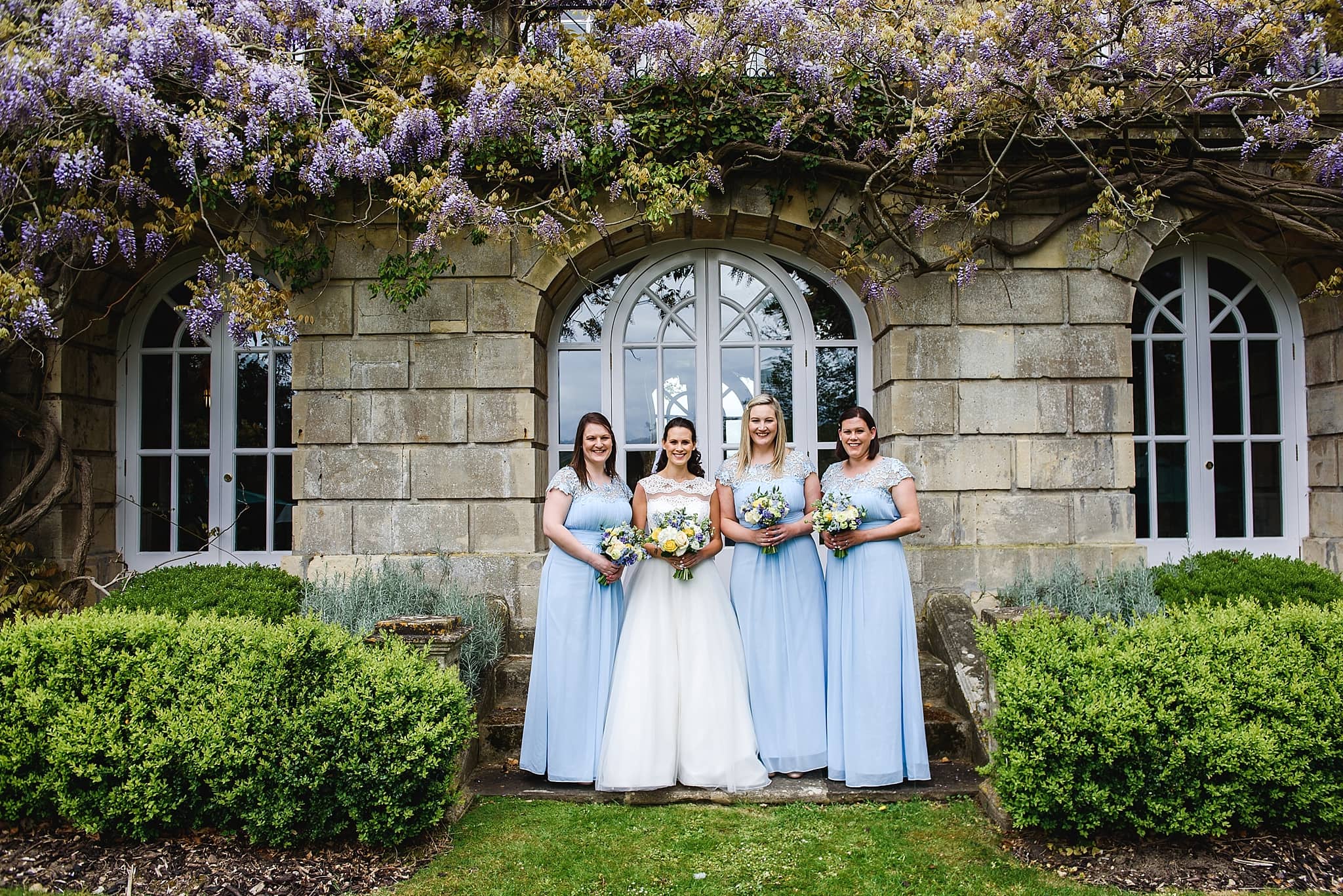 Bridesmaids stood in the garden of Bailbrook House