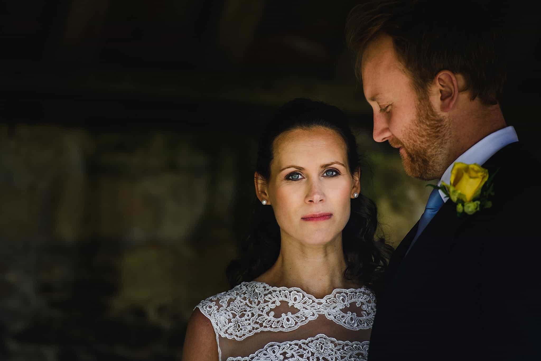 Bride and groom stood inside a barn at Wick Farm wedding venue