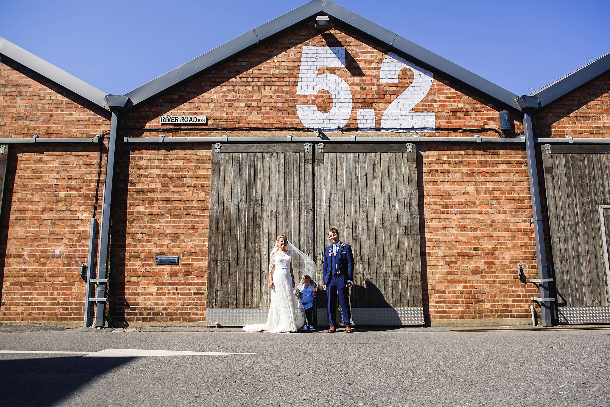 Couple stood in front of Unit 5.2 at their paintwork's wedding