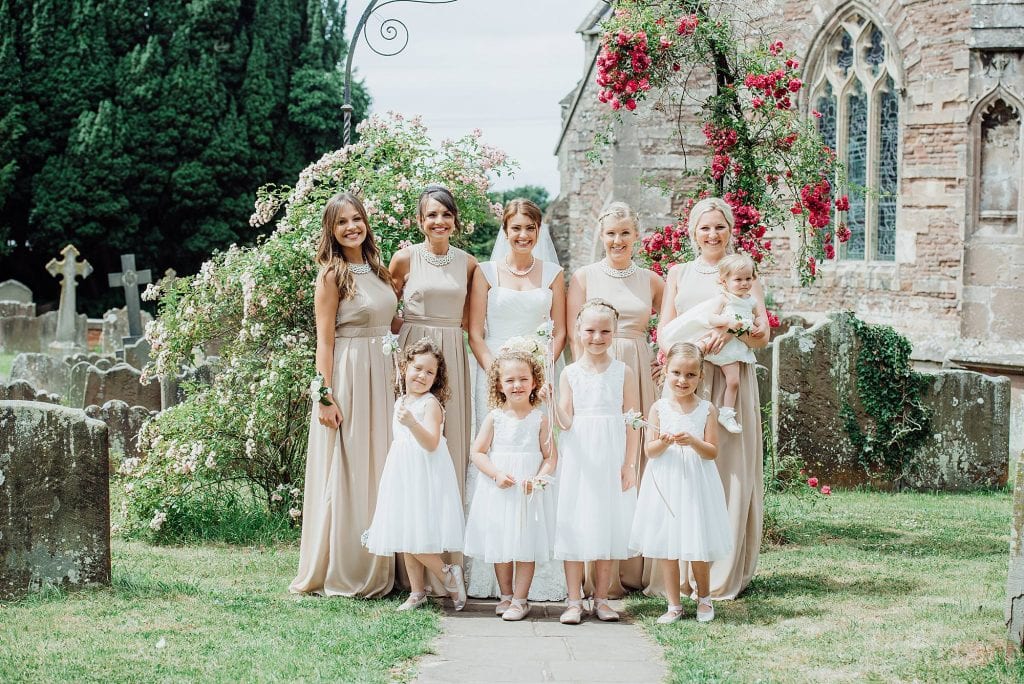 Bridesmaids stood posing in the grounds of St Michael's church Winterbourne Bristol