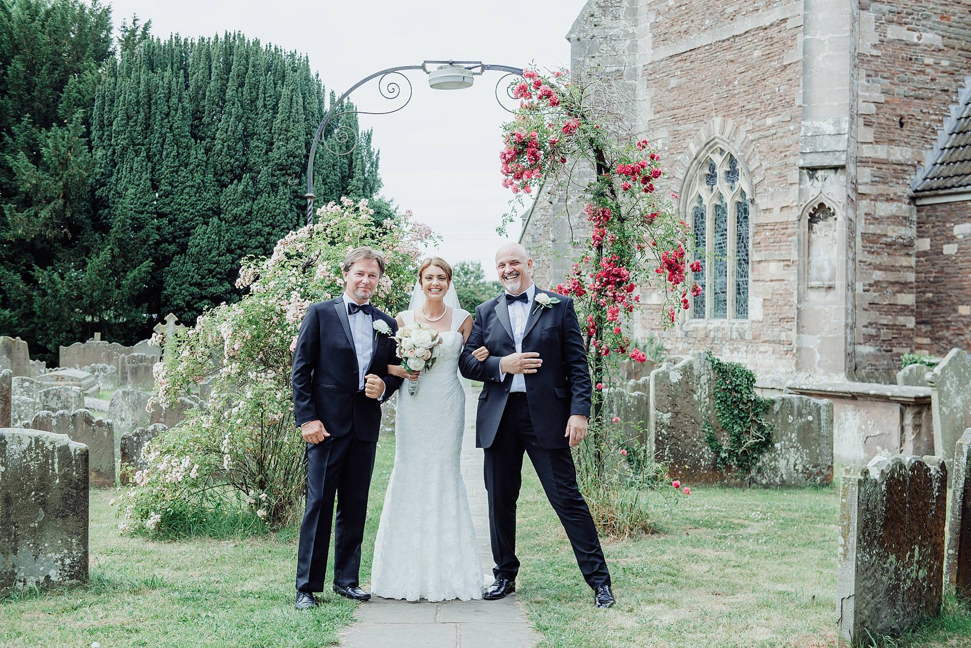 Wedding at St Michael's church Winterbourne Bristol 5 Bride stood with her two fathers outside of St Michael's church Winterbourne