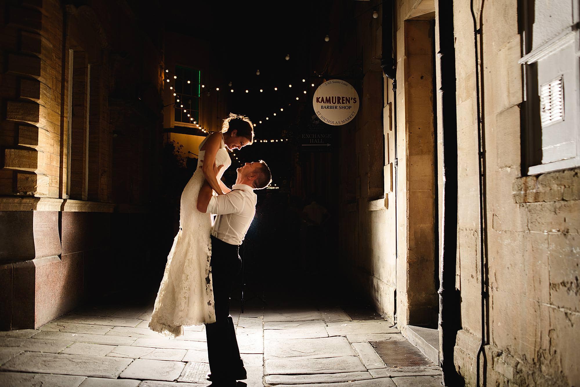 Wedding at St Michael's church Winterbourne Bristol 18 groom picks up his bride at night outside their Rummer hotel wedding Bristol