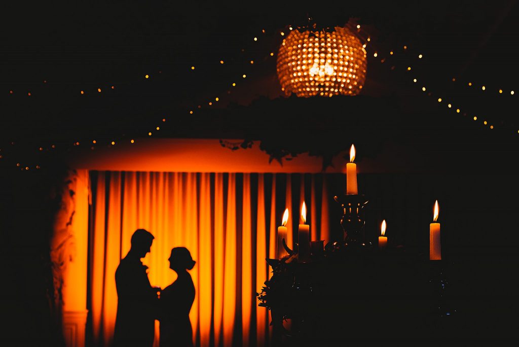 silhouette of a couple in front of the ballroom curtain