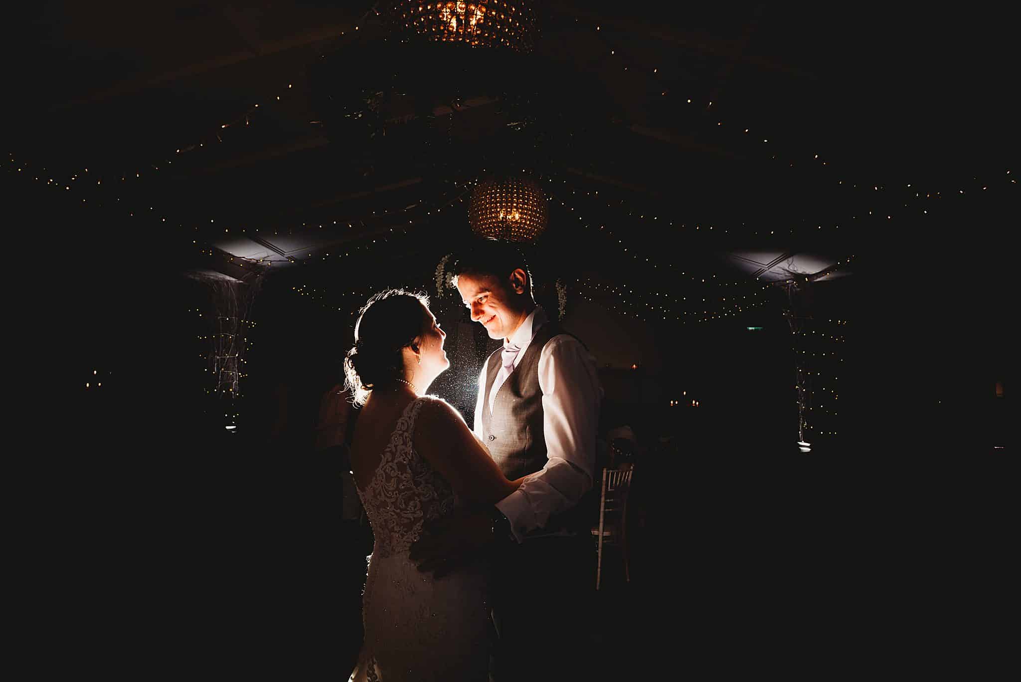 couple back lit on the dance floor - Manor by the Lake wedding photographer