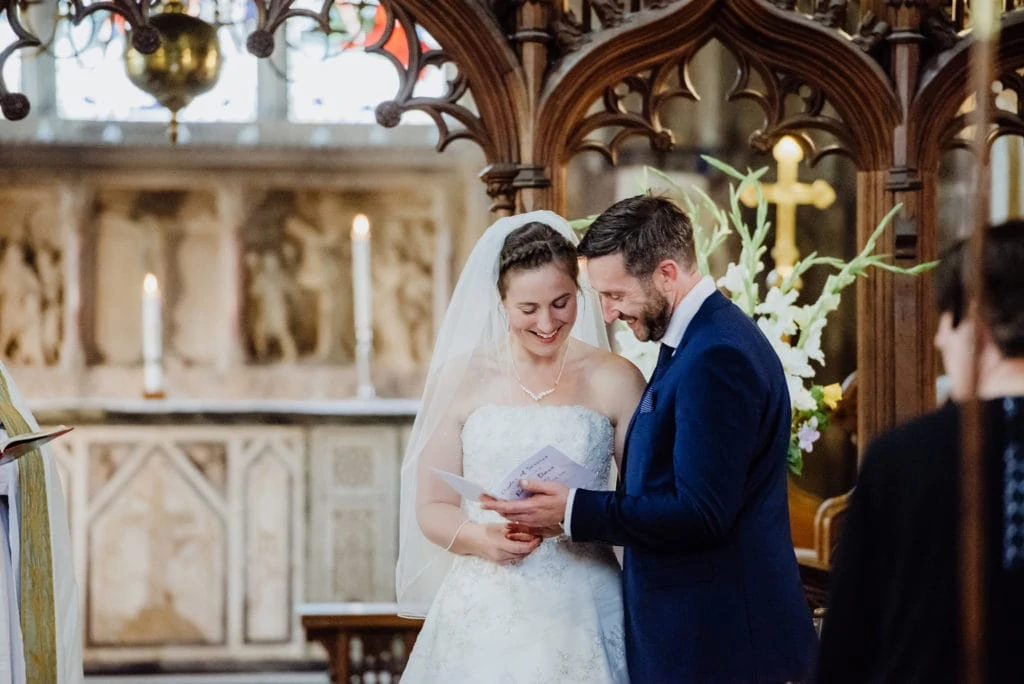 St-Andrews-church-Mells-wedding-photographer -couple sing hymns on wedding day