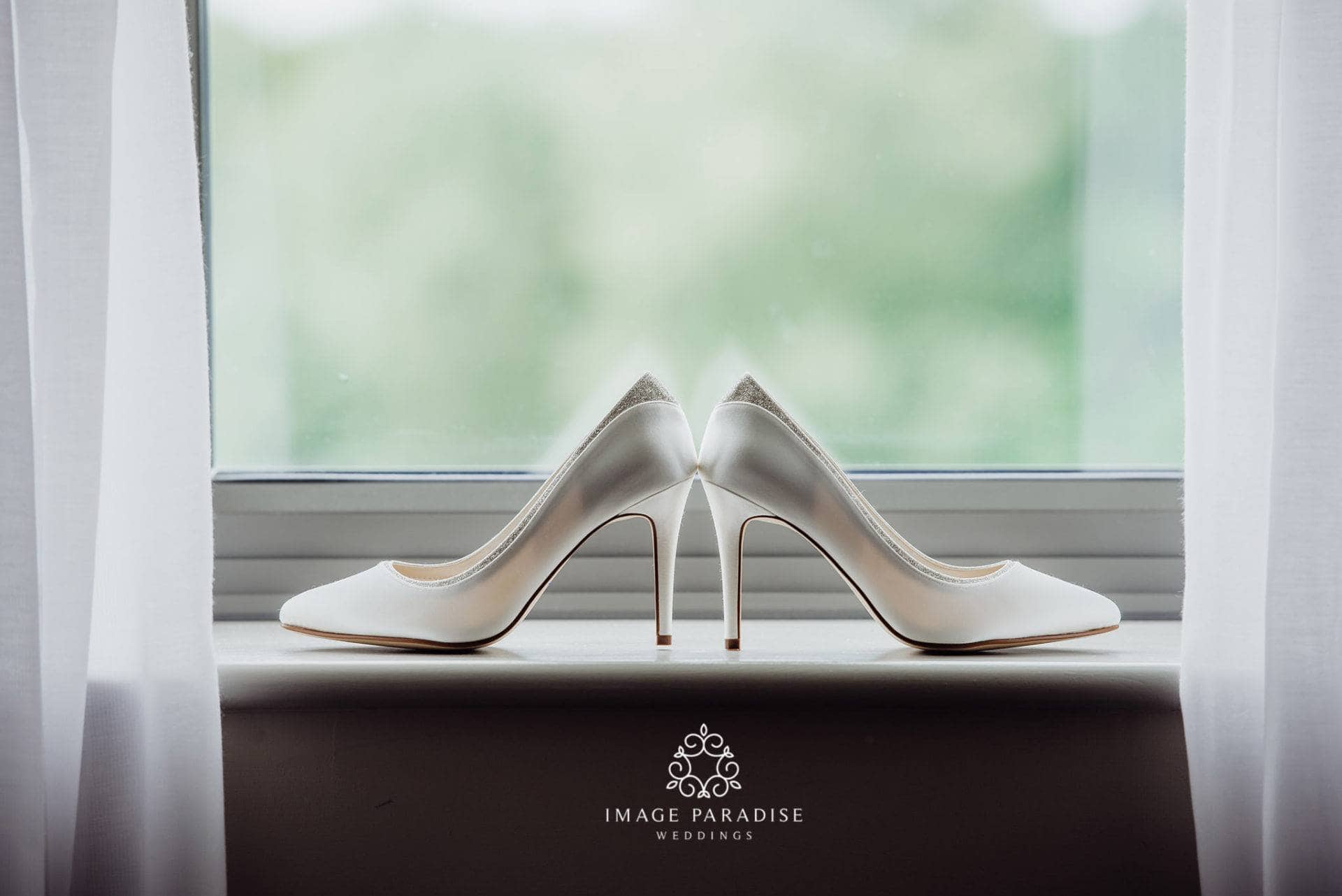 Cotswolds Hotel & Spa wedding photography | Chipping Norton photographer 6 Brides wedding shoes in the window of Cotswolds Hotel Spa wedding venue