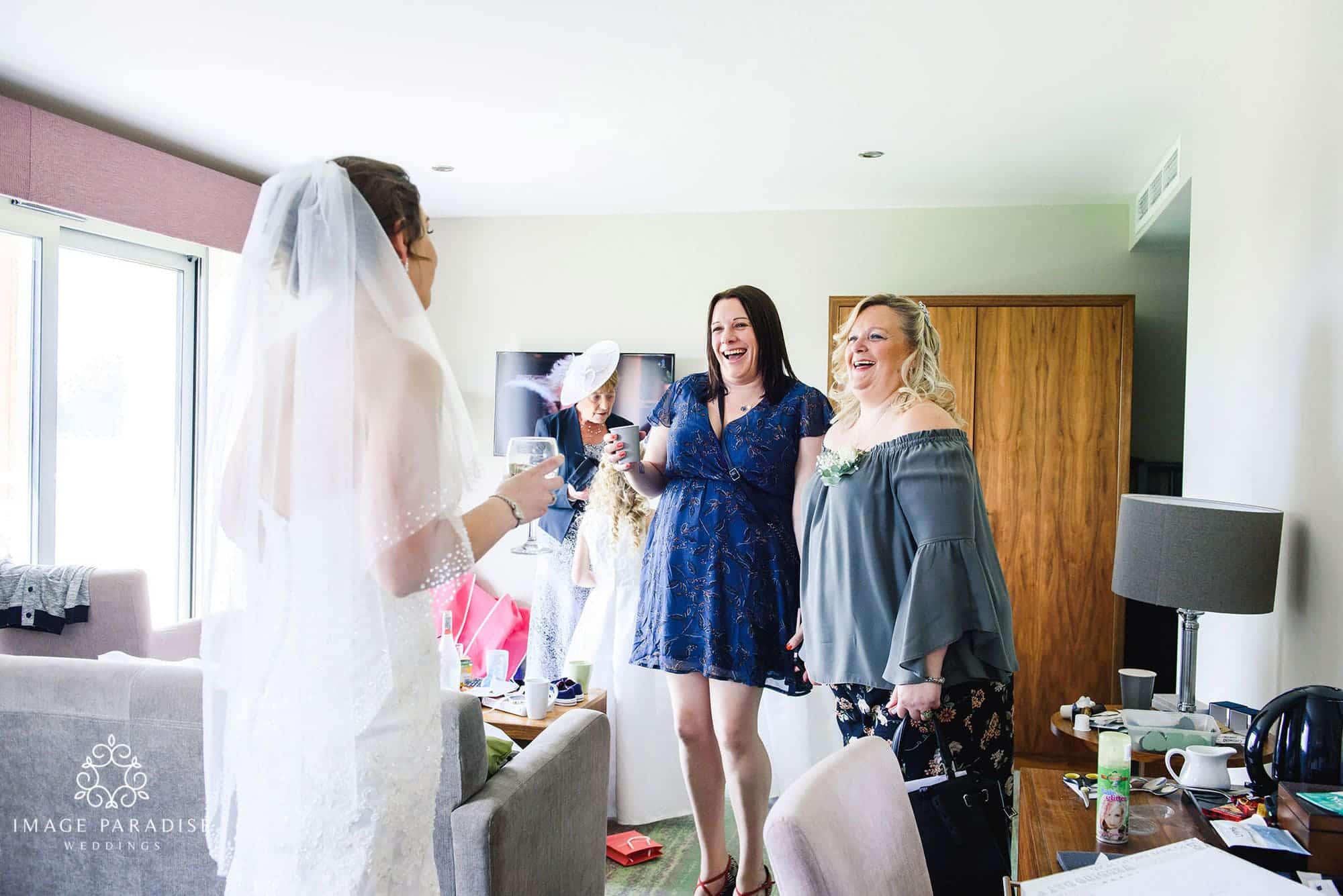 Cotswolds Hotel & Spa wedding photography | Chipping Norton photographer 9 bride reveals her dress to her friends