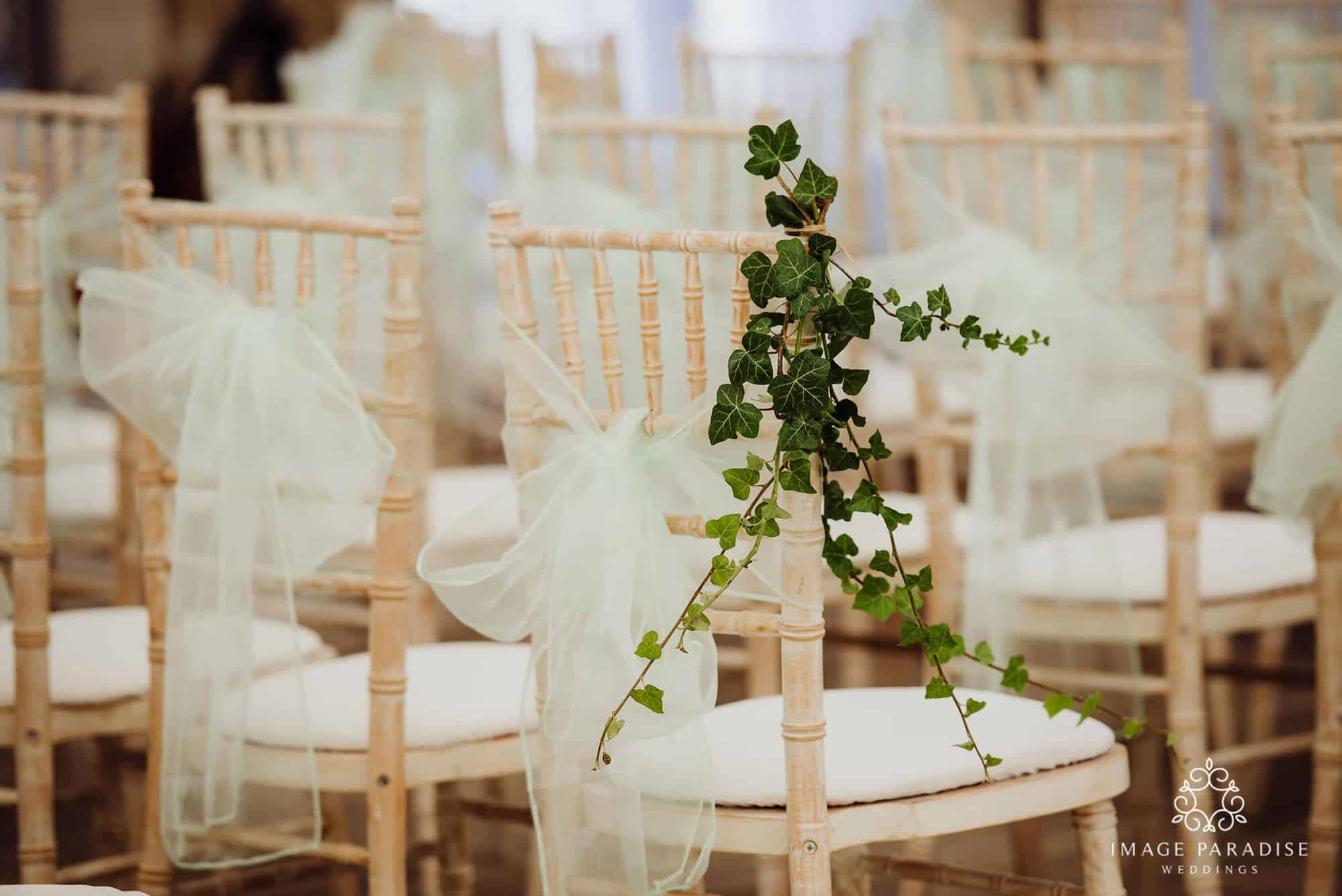 Cotswolds Hotel & Spa wedding photography | Chipping Norton photographer 4 Close up view of a wedding chair with cream bow and flowers at the Cotswold hotel and spa wedding venue