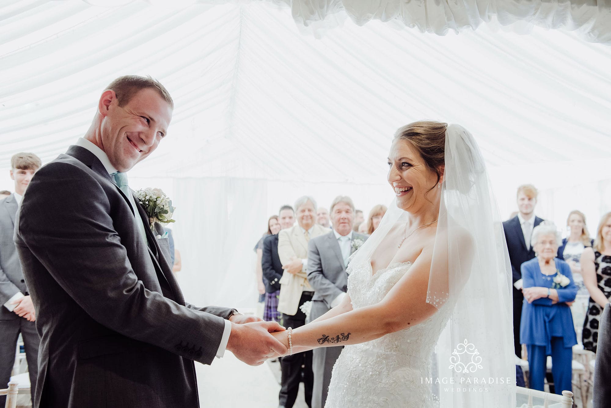 Cotswolds Hotel & Spa wedding photography | Chipping Norton photographer 16 wedding ceremony at the Cotswolds hotel and spa where bride and groom smile and hold hands