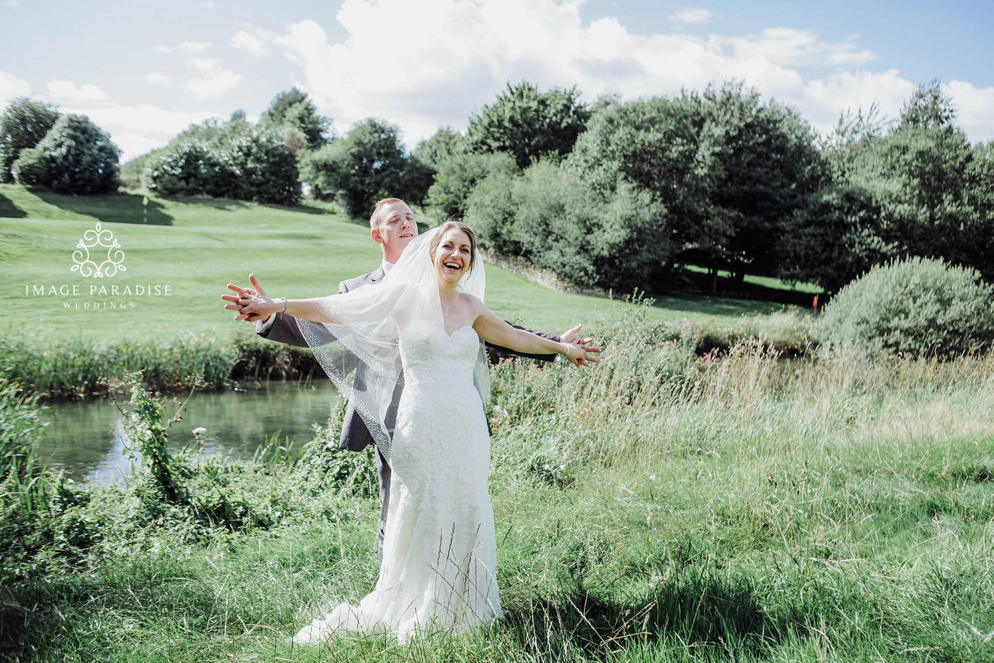 Cotswolds Hotel & Spa wedding photography | Chipping Norton photographer 29 wedding photography of bride and groom posing in front of the lake on the golf course of the Cotswolds hotel and spa