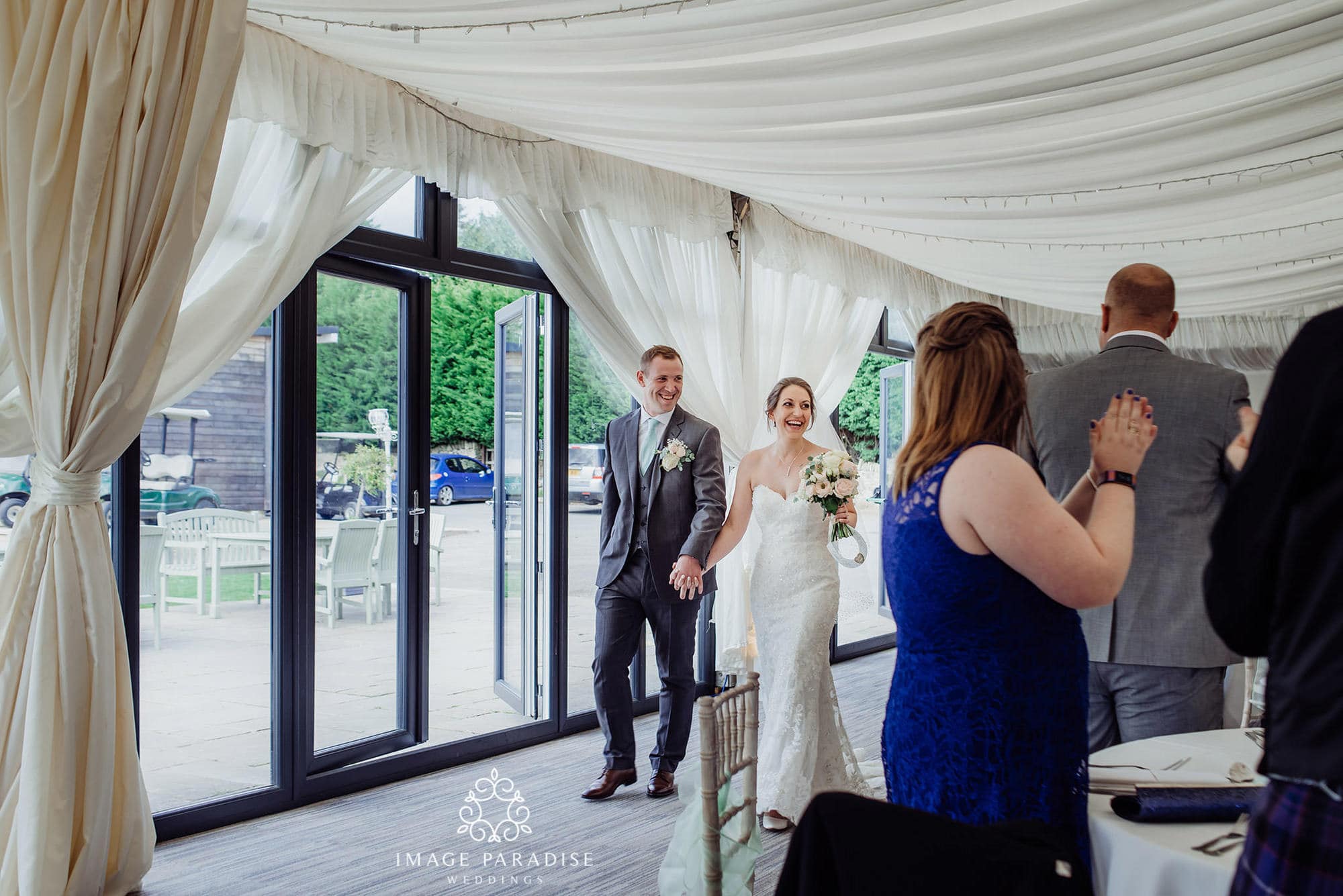 Cotswolds Hotel & Spa wedding photography | Chipping Norton photographer 31 bride and groom make an entrance into the marquee at the Cotswolds hotel and spa