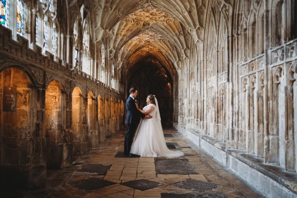 Bride and groom facing each other in Gloucester Cathedral