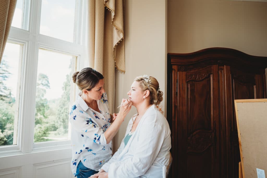 Bride getting makeup Orchardleigh House wedding