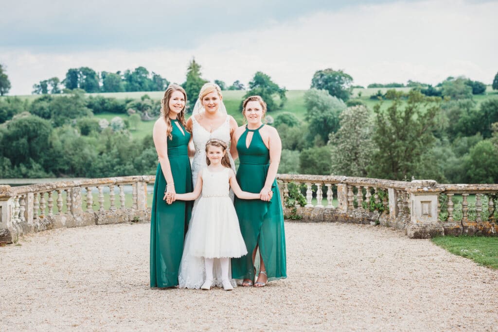 Bride and bridesmaids stood in the grounds of Orchardleigh House Estate