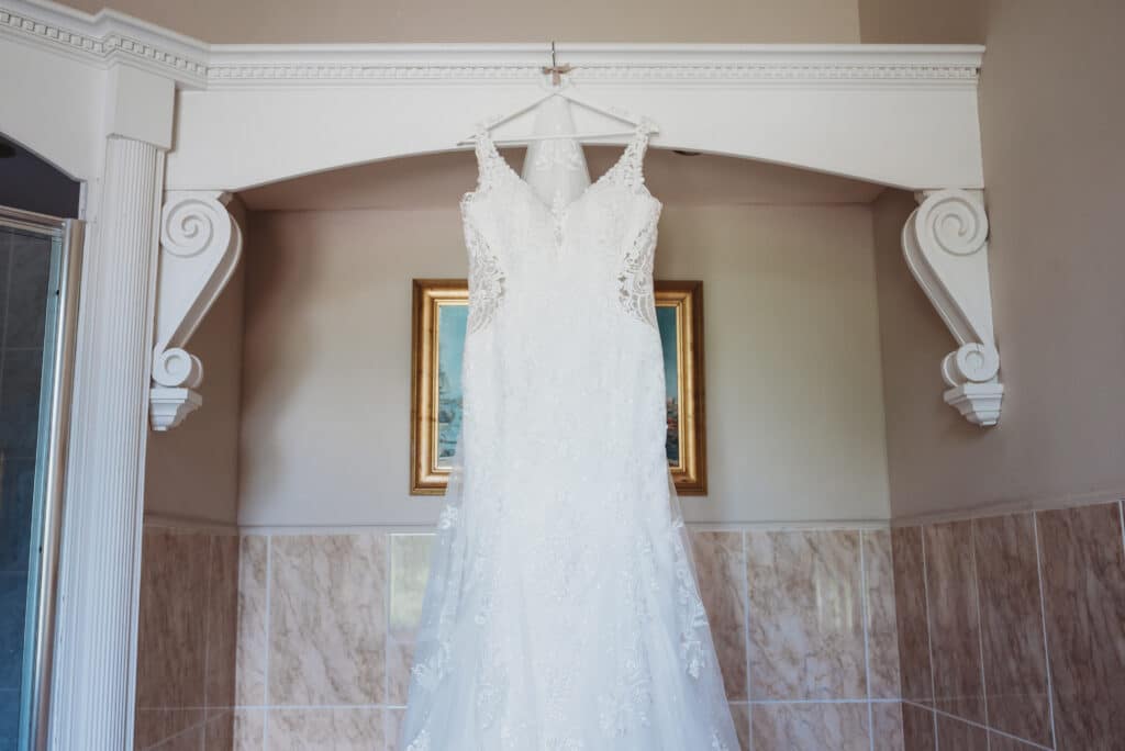 wedding Dress hanging in the bathroom at Orchardleigh 