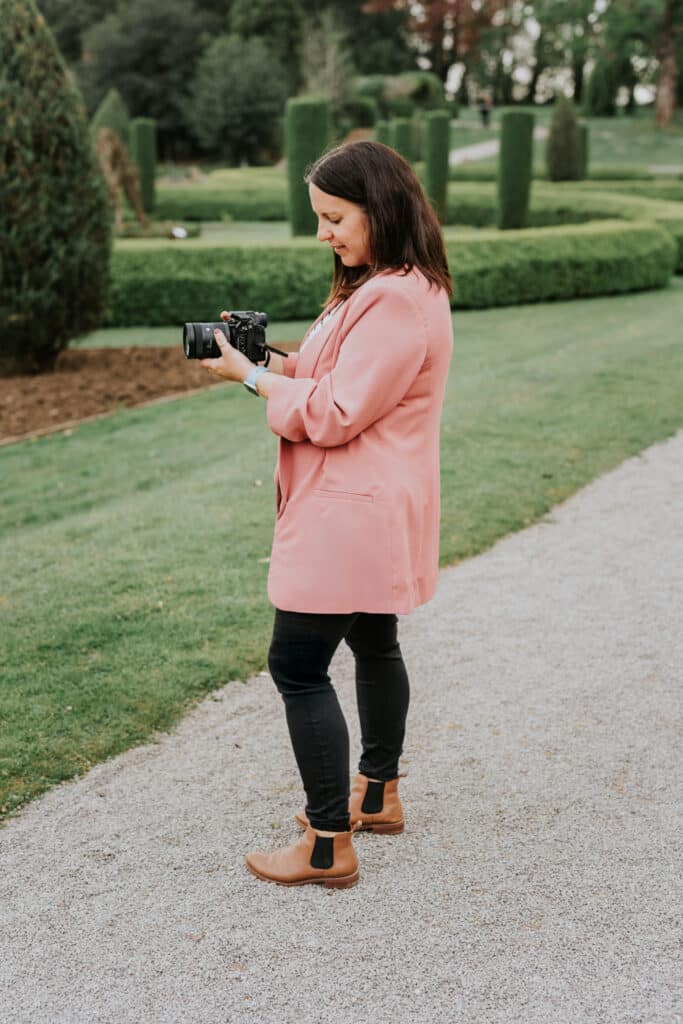 a candid photo of videographer Nicola Hesketh filming on a wedding day.